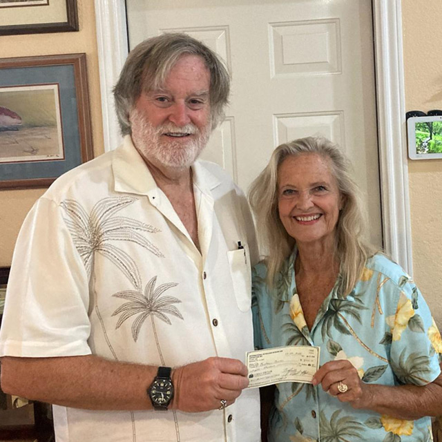 Bryce giving check to Cindy